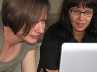 Lecturer and Claire Salter looking at a laptop screen